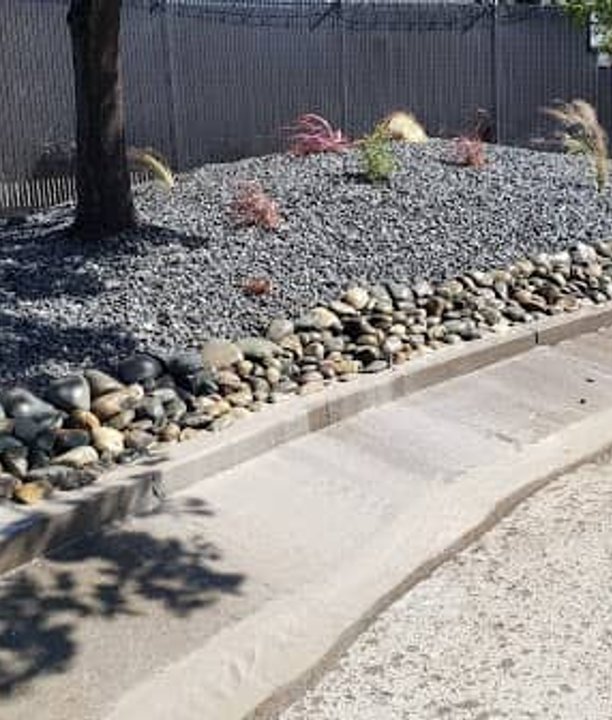 Decorative gray stone edging along a landscaped pathway