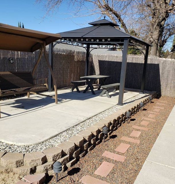 Custom backyard patio with pergola and stone features