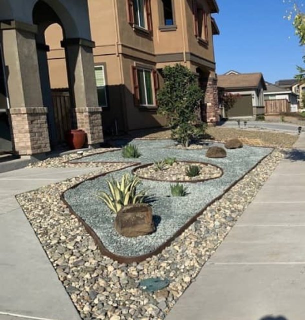 Outdoor stone patio with circular design and fire pit