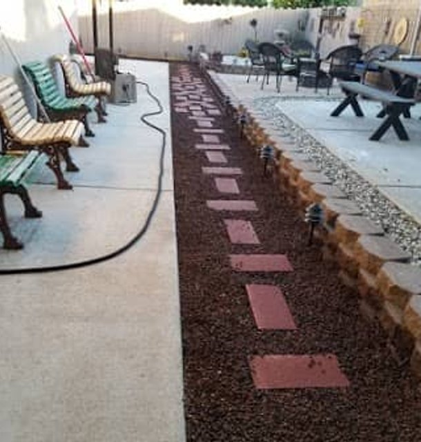 Custom outdoor seating area with concrete and gravel landscaping
