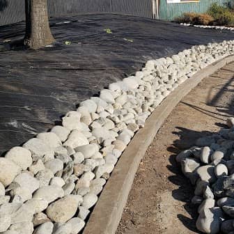 enlarged photo of after picture of a large light pink stucco home