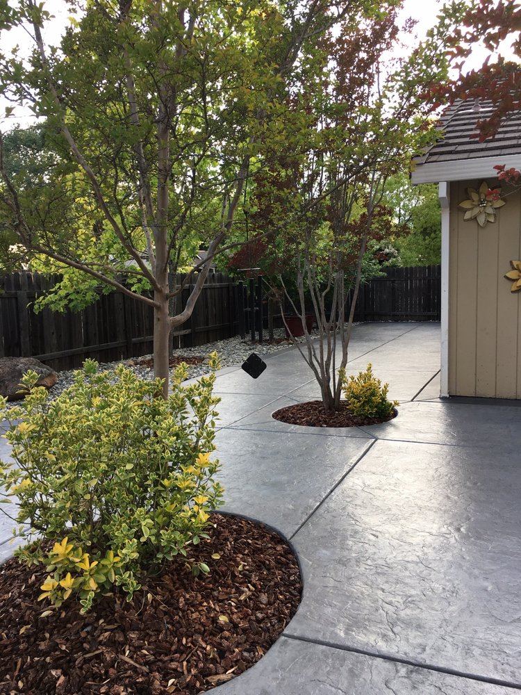 Scored concrete patio with turf Elk Grove