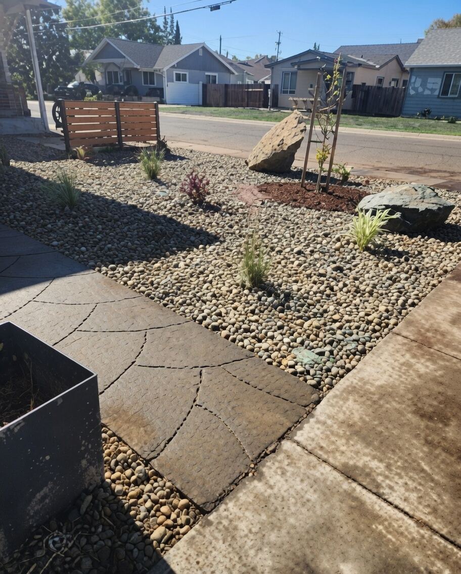 Flagstone path with river rock and boulders in drought-tolerant front yard